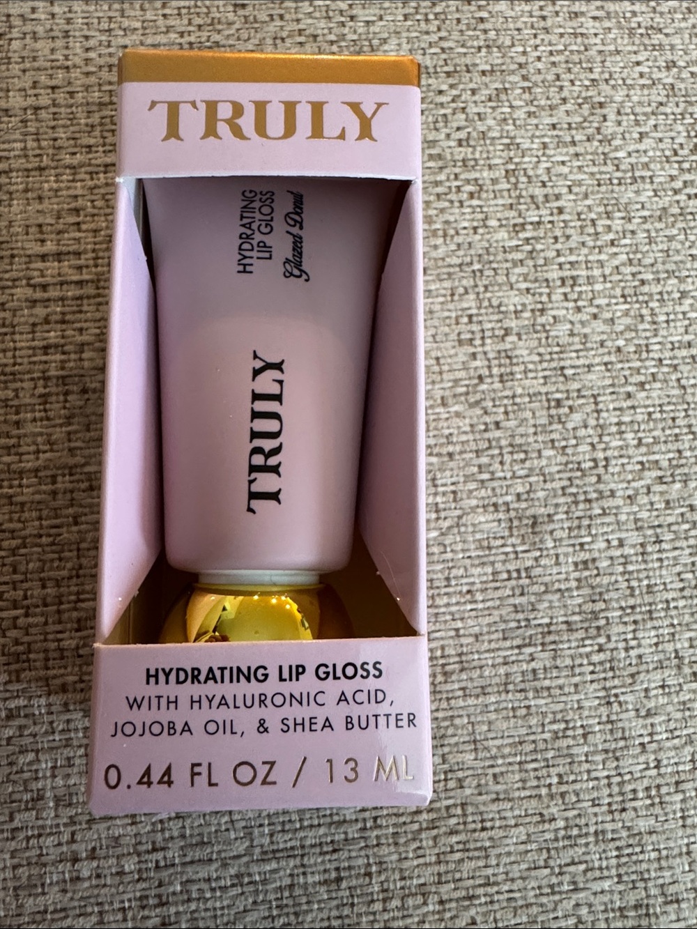 TRULY Hydrating Lip Gloss in Soft Pink with Gold Cap. Glazed Donut